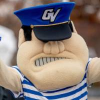 Louie gives the "anchor up" sign at the tailgate